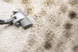 Person using a vacuum on carpet